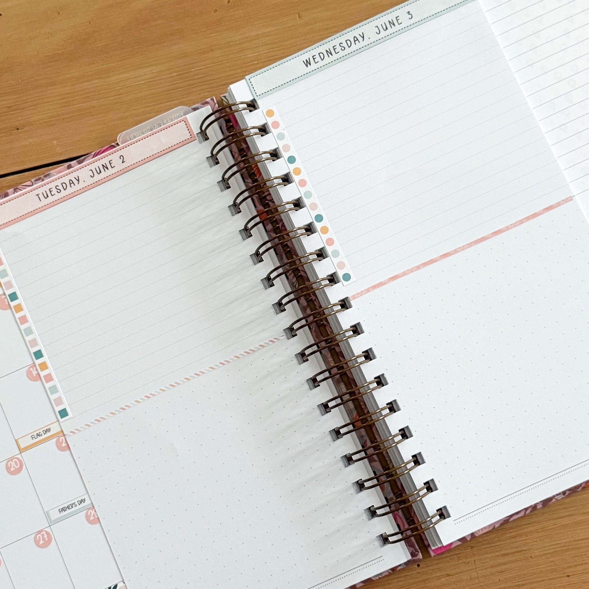 an open spiral-bound notebook with a blank page, resting on a wooden surface.