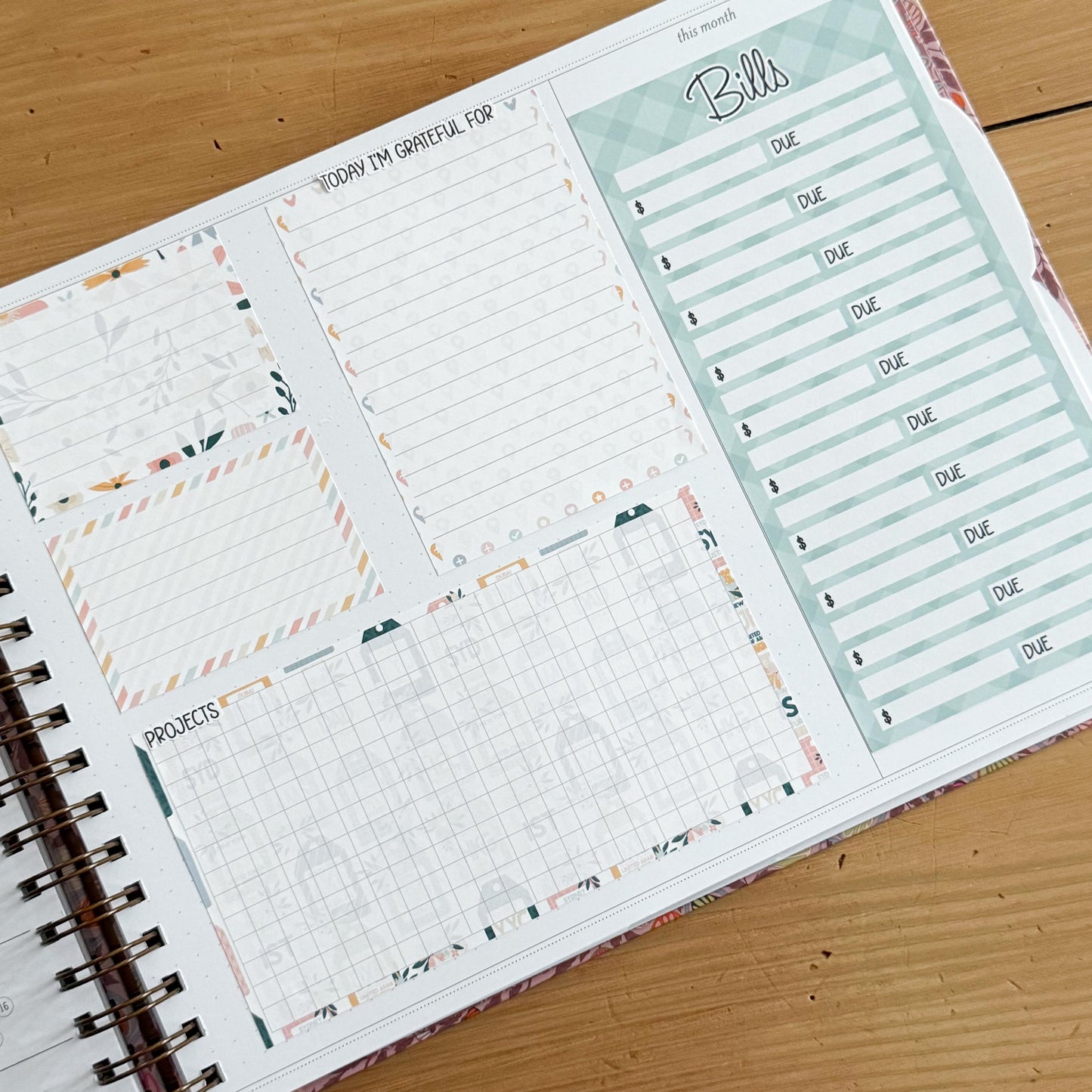 The image is a spiral-bound notebook with a page dedicated to tracking bills and other financial matters. The page includes a grid for recording due dates and a list of bills to be paid.