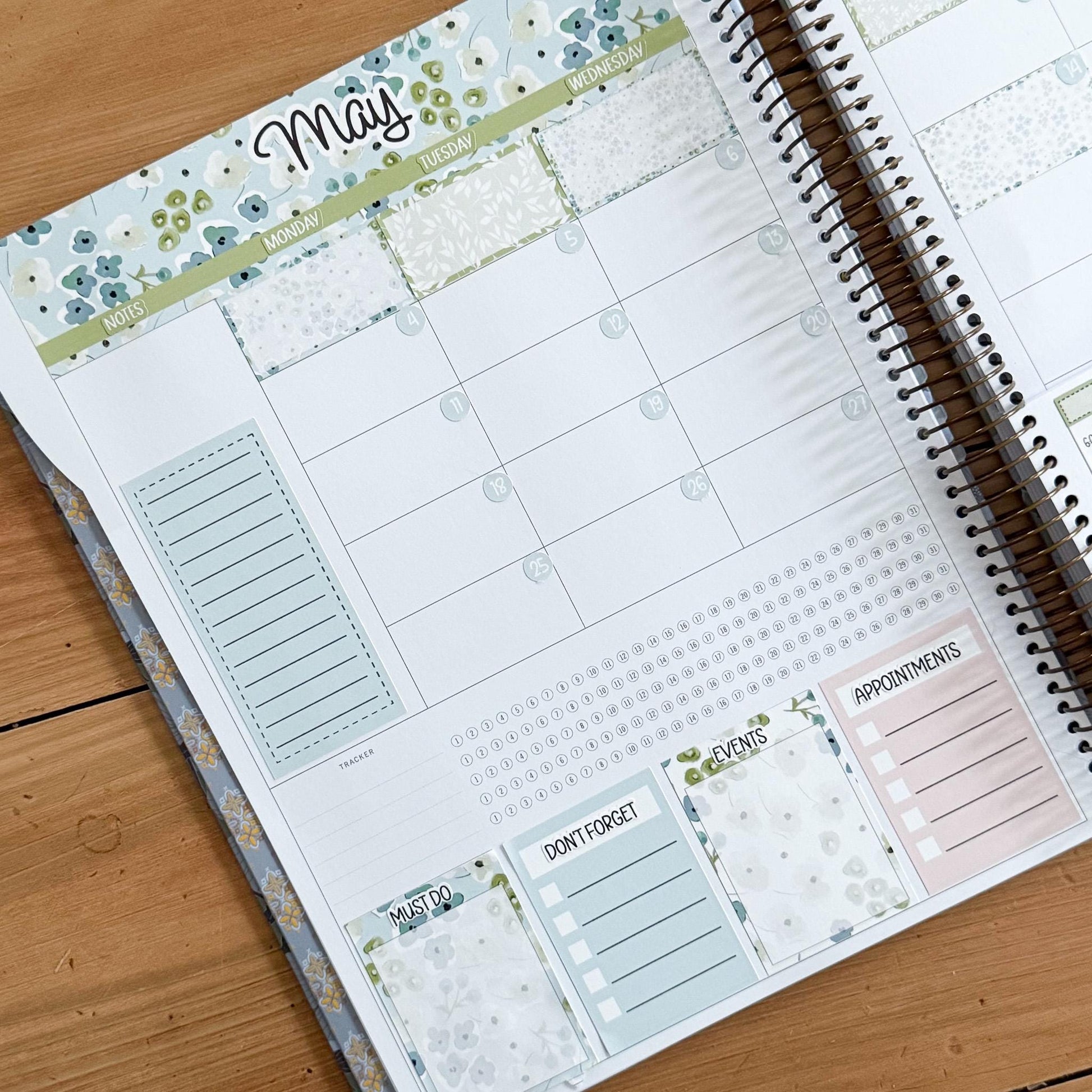 a spiral-bound notebook with a calendar page and various sections for planning and organizing tasks.