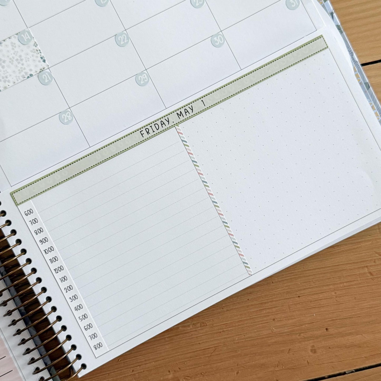 a spiral-bound notebook with a blank page and a calendar page with a date and a list of times.