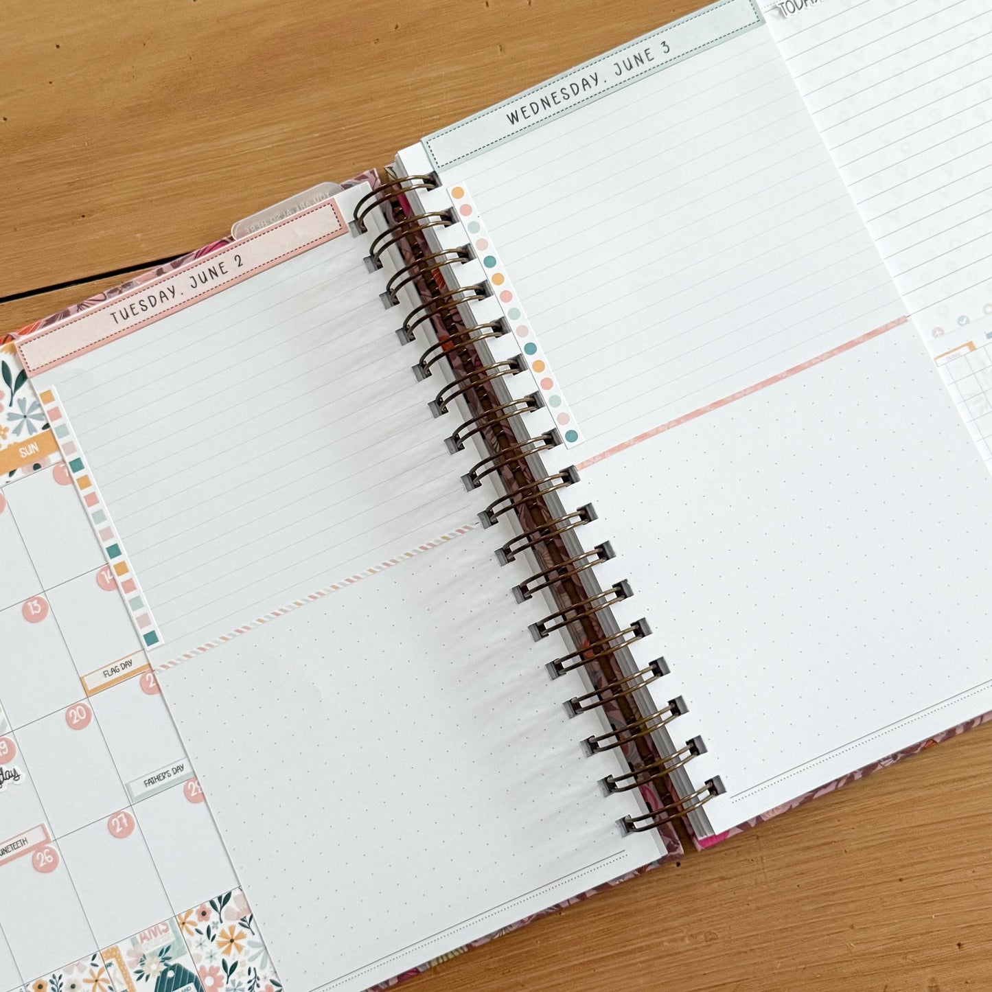 an open spiral-bound notebook with a blank page, resting on a wooden surface.
