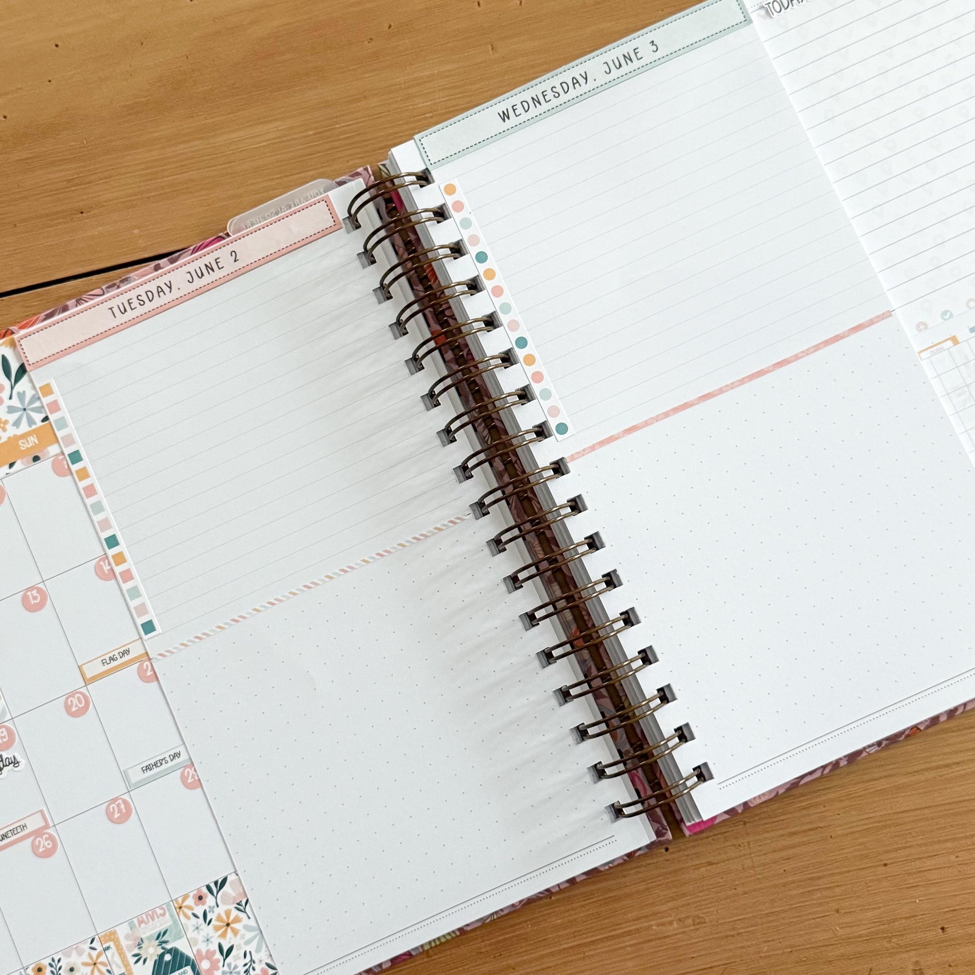 an open spiral-bound notebook with a blank page, resting on a wooden surface.